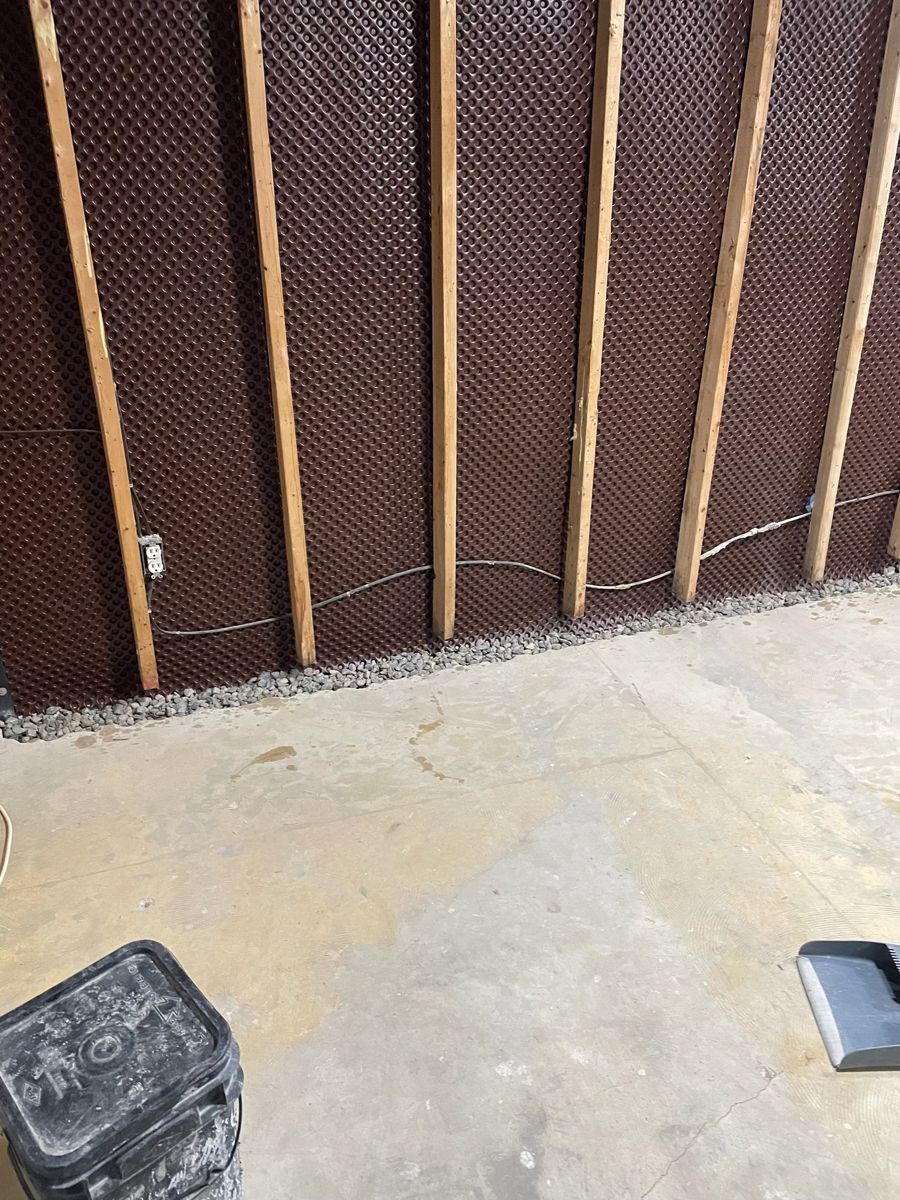 Delta membrane behind new basement wall framing